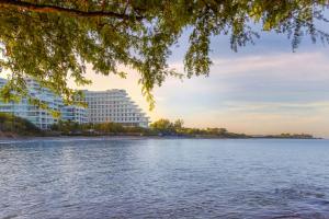 a large building on the shore of a body of water at Santa Marta Marriott Resort Playa Dormida in Santa Marta