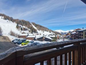 a group of cars parked in a parking lot in the snow at Les gémeaux- Plagne 1800- 100m des pistes- sauna privatif in La Plagne Tarentaise