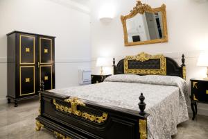 Postel nebo postele na pokoji v ubytování Casali Mediterranei Melissano by Palazzo Montagna