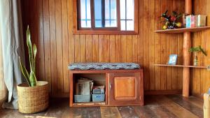 a small cabinet in a room with a window at Kemmiu Guest House Sao Tome in São Tomé