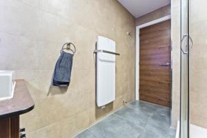 a bathroom with a shower and a towel on the wall at Bloom Court -Sleeps 6-Free Parking with Workspace & High-Speed WiFi in Birmingham +36 photos