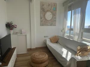 a living room with a couch and a large window at IRIVI 9 Apartment in Aguadulce