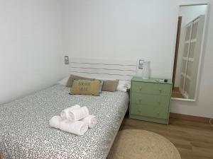 a bedroom with a bed with towels on it at IRIVI 9 Apartment in Aguadulce +9 photos