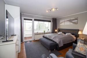 a bedroom with a bed and a tv and a couch at Atlantic 209 in Döse +26 photos