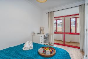 a room with a bed with a tray of food on it at HostWise - Elegant & Stylish Flat w/ Balcony in Portimão +10 photos