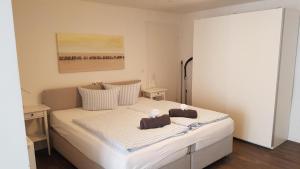 a bedroom with a bed with two pillows on it at Hafenloft App 3 in Norderney