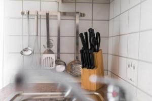 a kitchen counter with a knife block and utensils at Mayglück App 1 in Norderney