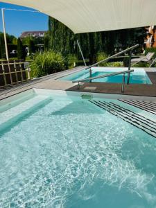 a swimming pool with blue water in a building at Art Hotel superior in Zalakaros +33 photos