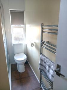 a small bathroom with a toilet and a window at Woolly Hill House - Beautiful Townhouse in the Heart of Wooler in Wooler +32 photos