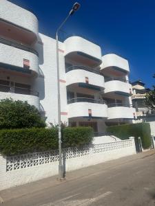 a white building with a street light in front of it at Two Bedroom Apartment in Santiago De La Ribera in San Javier +16 photos