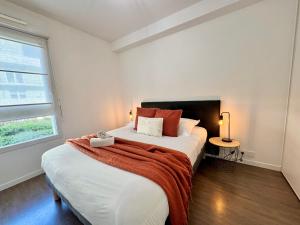 a bedroom with two beds and a window at Le Gregorien, Centre de Saint Gregoire in Saint-Grégoire