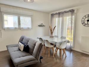 a living room with a couch and a table at Le Gregorien, Centre de Saint Gregoire in Saint-Grégoire