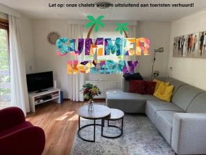 a living room with a couch and a table at Veluwe Happy Together in Epe