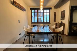 a dining room with a wooden table and chairs at KORN14 Loft - Parken, Küche in Freinsheim +13 photos