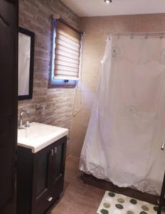 a bathroom with a sink and a shower at Casa de mar in Miramar +3 photos