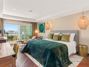 a bedroom with a bed and a living room at Boho Club in Marbella +37 photos