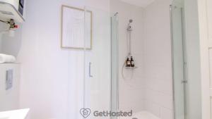 a bathroom with a shower with a glass door at La Villette - Charming flat in Pantin - GetHosted in Pantin