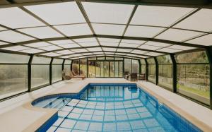an indoor swimming pool with a glass ceiling at Casas Alexandre in Pontevedra