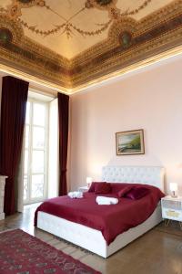 a bedroom with a large bed with a gold ceiling at ETNA QUEEN luxury home in Catania
