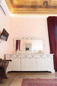 a white dresser with a mirror in a room at ETNA QUEEN luxury home in Catania
