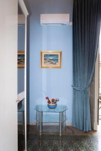 a blue room with a table and a blue wall at ETNA QUEEN luxury home in Catania