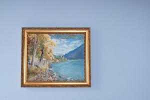 a reproduction of a painting of a river at ETNA QUEEN luxury home in Catania