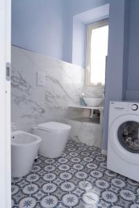 a bathroom with a toilet and a sink and a washing machine at ETNA QUEEN luxury home in Catania +52 photos