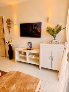 a room with a white cabinet and a tv on the wall at Atlantic Ocean & Beach Views - Playa Del Cura in Las Palmas de Gran Canaria