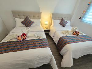 two beds with teddy bears on them in a bedroom at Acogedor Departamento en Cusco, Ideal para Familias y Amigos, Equipado y Céntrico in Cusco +13 photos