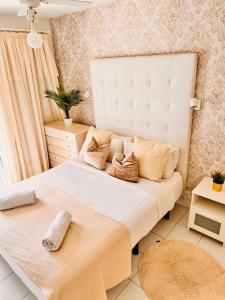 a bedroom with a large white bed with pillows at Atlantic Ocean & Beach Views - Playa Del Cura in Las Palmas de Gran Canaria +42 photos