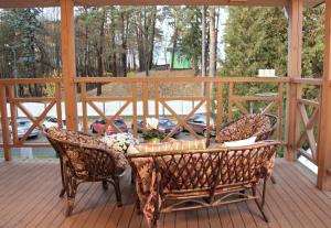 two chairs and a table on a porch at Tenisa klubs Jūra in Jūrmala