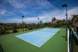 a tennis court with a tennis racket on it at The Ungasan Clifftop Resort in Uluwatu