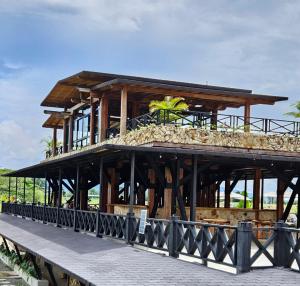 a wooden building on a pier next to the water at Hotel El Cielo en la Tierra in Quimbaya