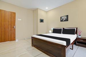 Ένα ή περισσότερα κρεβάτια σε δωμάτιο στο Hotel O Mint Leaf & Lodging