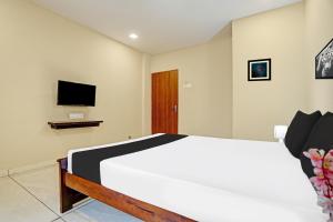 Μια τηλεόραση ή/και κέντρο ψυχαγωγίας στο Hotel O Mint Leaf & Lodging