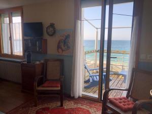 a living room with a view of the ocean at Hôtel Kermor in Concarneau