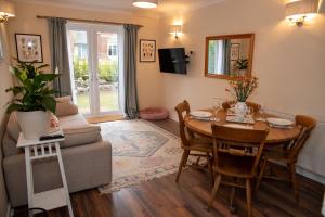 a living room with a table and a couch at Highcross Corner in Poulton le Fylde
