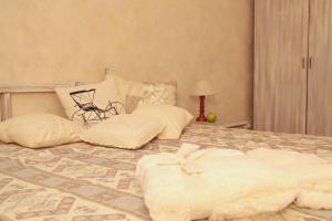 a bedroom with a bed with pillows on it at Tenisa klubs Jūra in Jūrmala