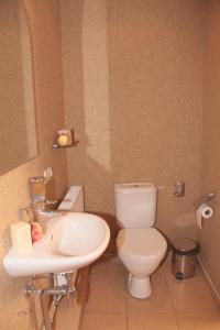 a bathroom with a toilet and a sink at Tenisa klubs Jūra in Jūrmala