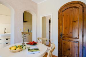 a kitchen with a table and a wooden door at The Lemon Garden Villa by Elite Villas in Pontone