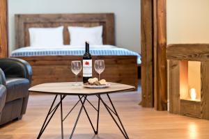 a table with a bottle of wine and two glasses at Apartament Starówka no1, no2, no3 in Toruń