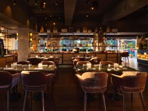 a restaurant with tables and chairs and a bar at Boho Club in Marbella