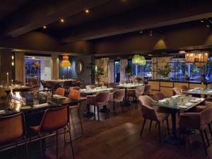 a restaurant with tables and chairs in a room at Boho Club in Marbella