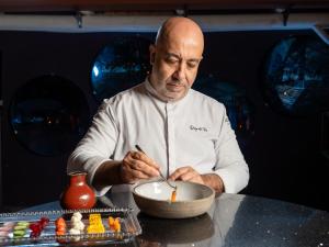 a man sitting at a table with a bowl of food at Boho Club in Marbella