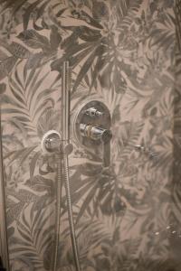 a shower in a bathroom with a wall at La Chicca di Sant'Agata in Brescia +28 photos