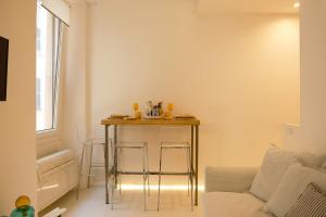 a living room with a table and a couch at La Chicca di Sant'Agata in Brescia