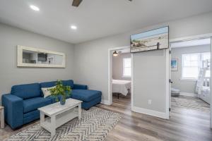 a living room with a blue couch and a table at Surf Shore Properties in North Wildwood