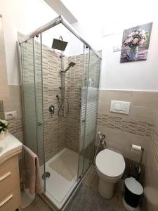 a bathroom with a shower and a toilet at A casitta in Giardini Naxos +19 photos