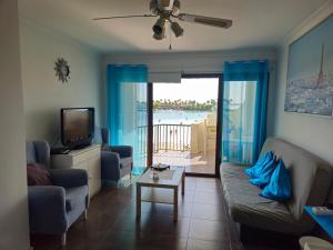 a living room with a couch and a tv at Carabela in Port d'Alcudia
