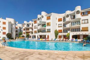 a swimming pool in front of some apartment buildings at Carabela in Port d'Alcudia